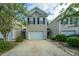 Inviting exterior view of a two-story home with a private driveway and lush greenery at 1320 Garland St, North Charleston, SC 29420