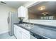 Kitchen featuring stainless steel appliances, a double sink, and an eat-through window to living area at 1320 Garland St, North Charleston, SC 29420