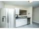 Well-equipped kitchen with stainless steel refrigerator and eat-through to living area at 1320 Garland St, North Charleston, SC 29420