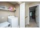 Bright laundry area with washer, dryer, storage shelf, and easy access to other areas of the home at 1320 Garland St, North Charleston, SC 29420