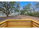 Exterior view from the wooden deck shows the backyard and wooded landscape at 1399 Old Whitesville Rd, Moncks Corner, SC 29461