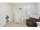 Bedroom featuring a white dresser, floral wall decor, a comfortable armchair, and soft natural light at 1413 Tannery, Johns Island, SC 29455