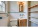 Bathroom featuring white tile, built-in shelving, and modern sink with classic hardware at 1418 Kentwood Circle Cir, Charleston, SC 29412