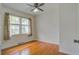 Charming bedroom with hardwood floors, ceiling fan, and a large window providing natural light at 1418 Kentwood Circle Cir, Charleston, SC 29412