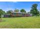 Charming brick home with well-manicured lawn, bushes, and mature trees, and brick accents at 1418 Kentwood Circle Cir, Charleston, SC 29412