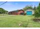 Single-story home with a lush front lawn and detached garage at 1418 Kentwood Circle Cir, Charleston, SC 29412