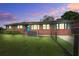 Charming brick home featuring a spacious lawn and a vibrant, blue-painted door and window shutters at 1418 Kentwood Circle Cir, Charleston, SC 29412