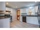 Modern kitchen with white cabinetry, granite countertops, stainless steel appliances and new tile floor at 1418 Kentwood Circle Cir, Charleston, SC 29412