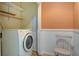 Laundry room with washing machine, built-in shelves, and chair at 1418 Kentwood Circle Cir, Charleston, SC 29412