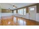 Inviting living room with hardwood floors, wainscoting, and large windows offering natural light at 1418 Kentwood Circle Cir, Charleston, SC 29412