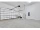 Spacious garage with a clean concrete floor, white walls, and an automatic door, ready for parking and storage at 1565 Juniper St, Charleston, SC 29407