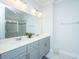 Bright bathroom featuring a double sink vanity with gray cabinets and a large mirror at 1610 Mermentau St, Mount Pleasant, SC 29466