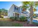Charming two-story home features a manicured lawn and a swaying palm tree at 1610 Mermentau St, Mount Pleasant, SC 29466