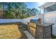 Outdoor kitchen with a stainless steel grill and stone counter, perfect for entertaining in the backyard at 1610 Mermentau St, Mount Pleasant, SC 29466