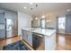 Kitchen island with stainless dishwasher and sink, and hardwood flooring at 1610 Mermentau St, Mount Pleasant, SC 29466