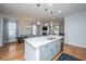 Bright open kitchen showcasing a central island, dining area, and hardwood floors at 1610 Mermentau St, Mount Pleasant, SC 29466