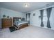 Comfortable main bedroom with a large bed, wooden dresser, and gray curtains at 1610 Mermentau St, Mount Pleasant, SC 29466