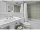 Bright bathroom with a pedestal sink, standard toilet, and white tiled shower/tub at 1613 Live Oak Park, Seabrook Island, SC 29455