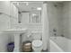 Clean bathroom with a pedestal sink and white tiled shower/tub at 1613 Live Oak Park, Seabrook Island, SC 29455