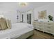 Airy bedroom with light hardwood floors and a quaint desk by the bright, sunny windows at 1613 Live Oak Park, Seabrook Island, SC 29455