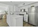 Modern kitchen with stainless steel appliances, white cabinetry and an eat-in island at 1613 Live Oak Park, Seabrook Island, SC 29455