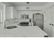 Bright kitchen featuring stainless steel appliances, white cabinets, and solid surface countertops at 1613 Live Oak Park, Seabrook Island, SC 29455