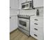 Kitchen featuring stainless steel oven, white cabinets, and ample counter space at 1613 Live Oak Park, Seabrook Island, SC 29455