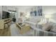 Inviting living room featuring a sofa, striped armchairs, and a sliding door with access to a balcony at 1613 Live Oak Park, Seabrook Island, SC 29455