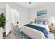 Bright bedroom with a large bed, stylish blue accents, and an ensuite bathroom at 1623 Telfair Way, Charleston, SC 29412