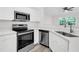 Bright kitchen featuring stainless steel appliances, white cabinetry, and light countertops at 1623 Telfair Way, Charleston, SC 29412