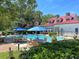 Stunning community pool featuring a large tanning deck, and tables and chairs under umbrellas at 1623 Telfair Way, Charleston, SC 29412