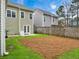 Spacious backyard with well-kept grass, patio, and garden space accessible via sliding glass doors at 1747 Towne St, Johns Island, SC 29455