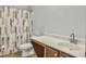 Bathroom featuring a framed shower curtain, white countertop, and wood cabinets at 1747 Towne St, Johns Island, SC 29455