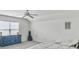 Bright bedroom features a window with blinds, blue dresser, and comfortable bed with white linens at 1747 Towne St, Johns Island, SC 29455