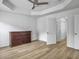 Bedroom features a tray ceiling with a ceiling fan, wood floors, and a traditional wood dresser at 1747 Towne St, Johns Island, SC 29455