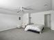 Spacious bedroom features a ceiling fan, white walls, and a cozy sitting area with a large bed and comfortable sofa at 1747 Towne St, Johns Island, SC 29455