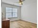 Cozy bedroom features a ceiling fan, wood floors, a bright window with blinds, and a wooden dresser at 1747 Towne St, Johns Island, SC 29455