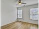 Bright bedroom features wood floors, ceiling fan, and natural light from two large windows at 1747 Towne St, Johns Island, SC 29455