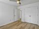 Bright bedroom features a ceiling fan, wood floors, and ample closet space with white doors at 1747 Towne St, Johns Island, SC 29455