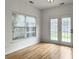 Bonus room features a window and glass patio doors providing access to the backyard at 1747 Towne St, Johns Island, SC 29455