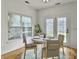 Bright dining area features a round table set for four near a window and door to the backyard at 1747 Towne St, Johns Island, SC 29455