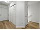 Hallway has wood floors, closets for storage, and access to multiple rooms and stairs at 1747 Towne St, Johns Island, SC 29455
