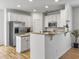 Open kitchen featuring a granite countertop, stainless steel appliances, and white cabinets at 1747 Towne St, Johns Island, SC 29455