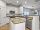 Charming kitchen boasts white cabinetry, stainless steel appliances, and granite countertops at 1747 Towne St, Johns Island, SC 29455