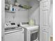 Bright laundry room featuring a new washer and dryer set with storage shelf above at 1747 Towne St, Johns Island, SC 29455