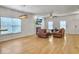 Open-concept living room featuring hardwood floors, a fireplace, and comfortable seating at 1747 Towne St, Johns Island, SC 29455