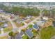 An aerial view shows a well-planned neighborhood with homes situated along winding streets and a large pond at 186 Jupiter Ln, Summerville, SC 29483