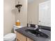 This half bathroom features a black granite sink, toilet, and wall mirror at 186 Jupiter Ln, Summerville, SC 29483