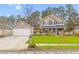 Charming two-story home with a well-manicured lawn, mature trees, and a detached garage at 186 Jupiter Ln, Summerville, SC 29483