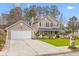 Charming two-story home with a manicured lawn and attached two-car garage at 186 Jupiter Ln, Summerville, SC 29483